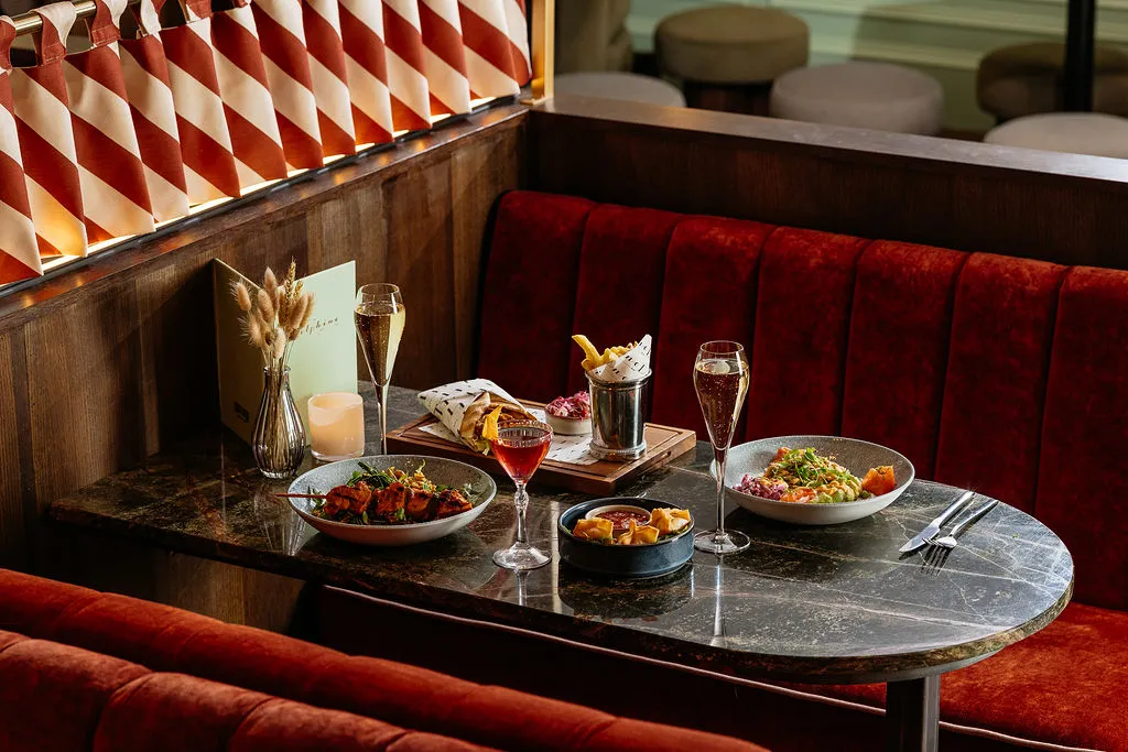 The Delphine — bar service and booth seating