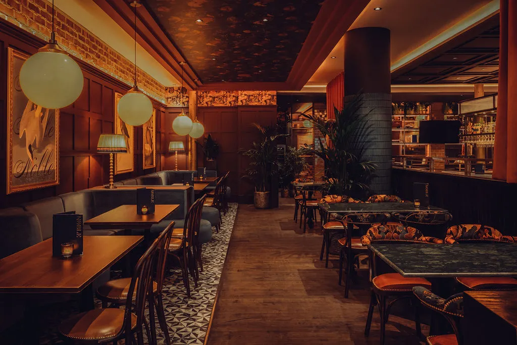 The Noble Public House — booth seating with green marble tables