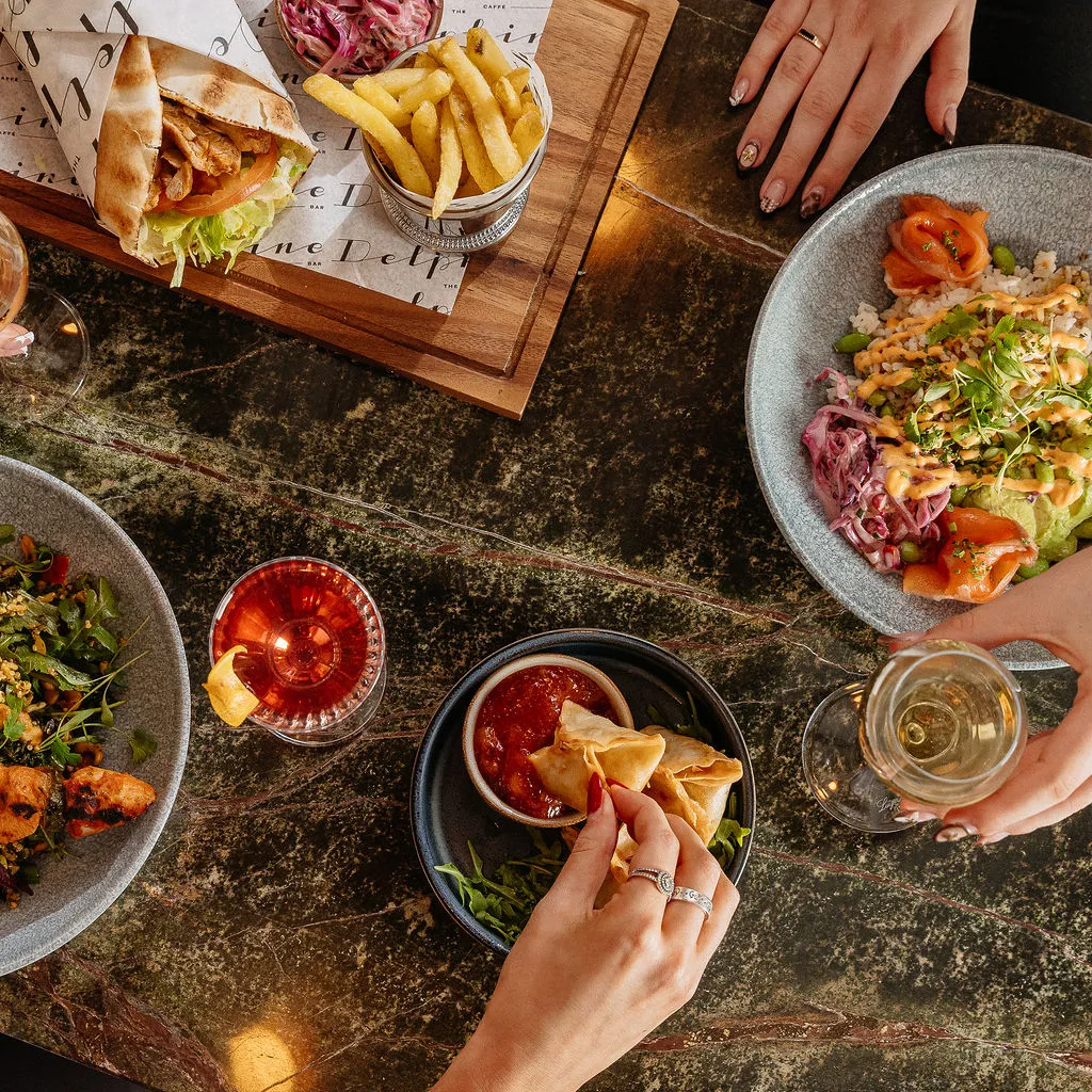 The Delphine — small-plates service on green marble