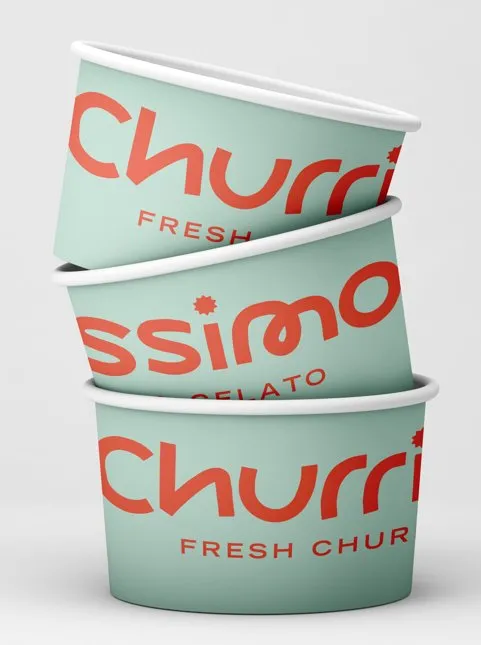 This image showcases a stack of three branded paper cups, designed for a dessert or snack concept. The cups feature a vibrant and playful aesthetic, with the brand name 'Churri' rendered in a bold, rounded coral sans-serif typeface against a soft mint green background. Subtle details like 'FRESH' and 'GELATO' are visible, hinting at the product, all presented under clean, bright studio lighting that emphasizes the crisp colors and simple, inviting design.