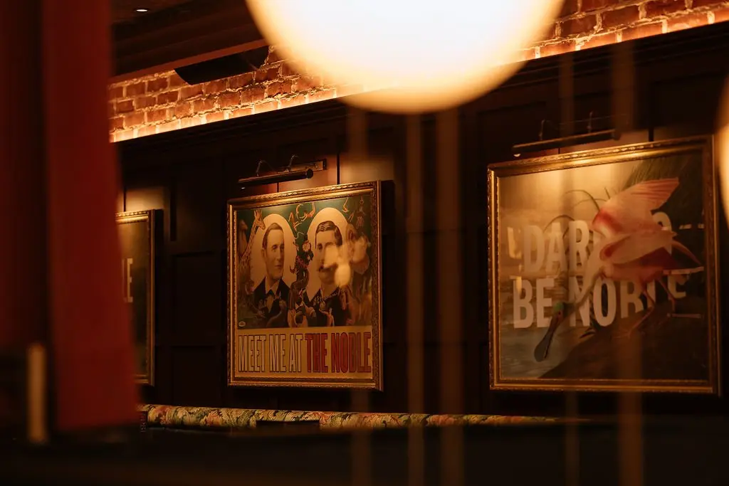 The Noble — dining room with framed poster wall, Glasgow