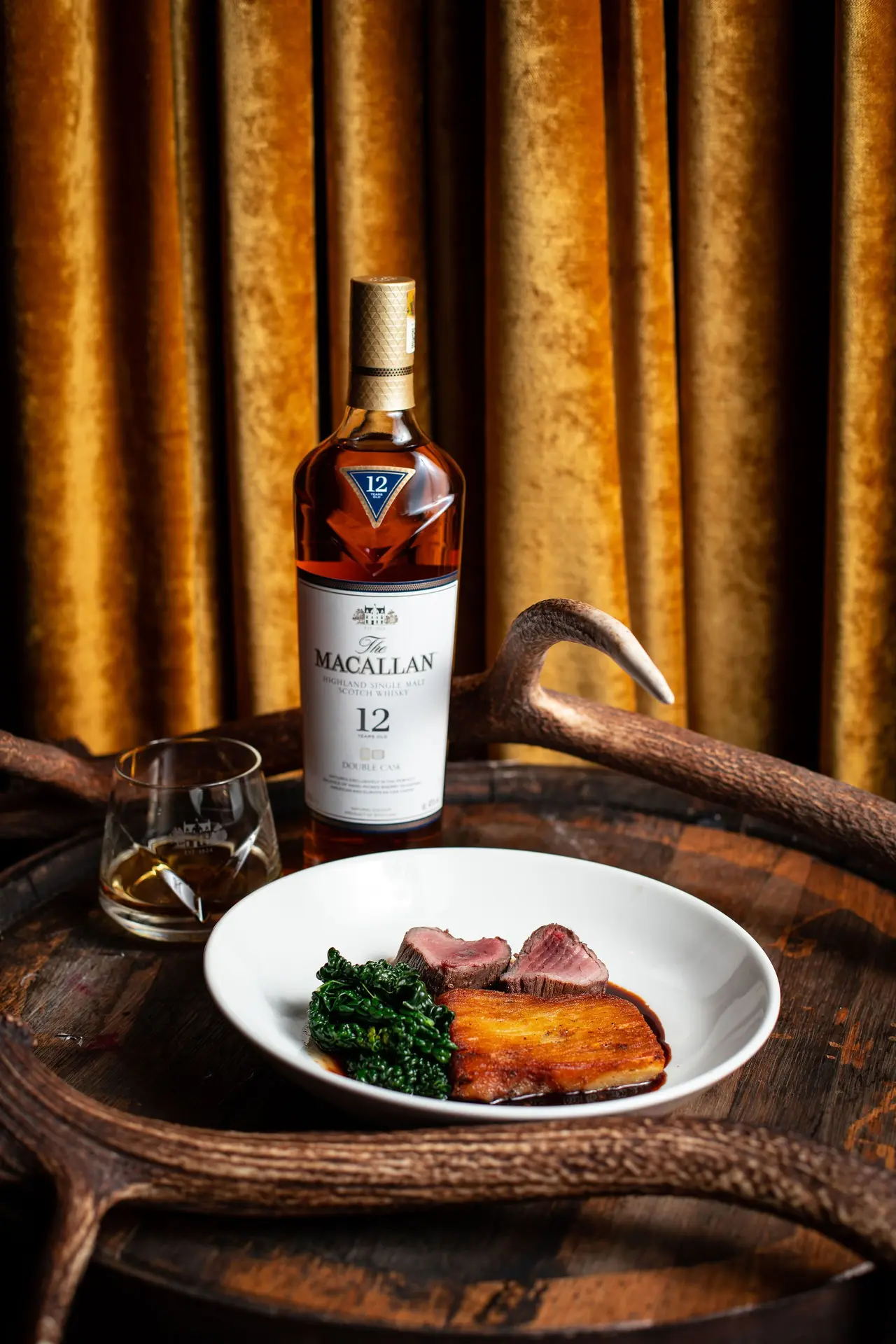 Whisky and venison pairing on an antler tray — drinks brand activation styling