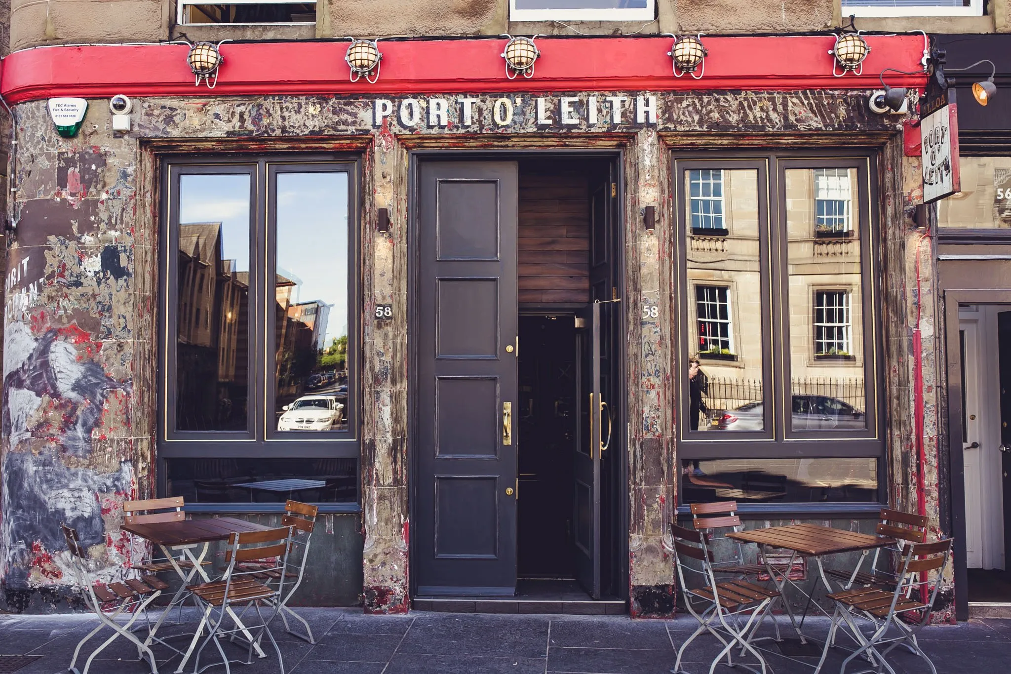 Port O' Leith — weathered corner-pub frontage with red fascia, Constitution Street, Leith